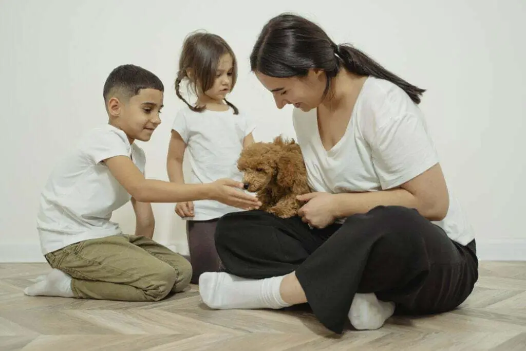 Mother is giving a dog for her children